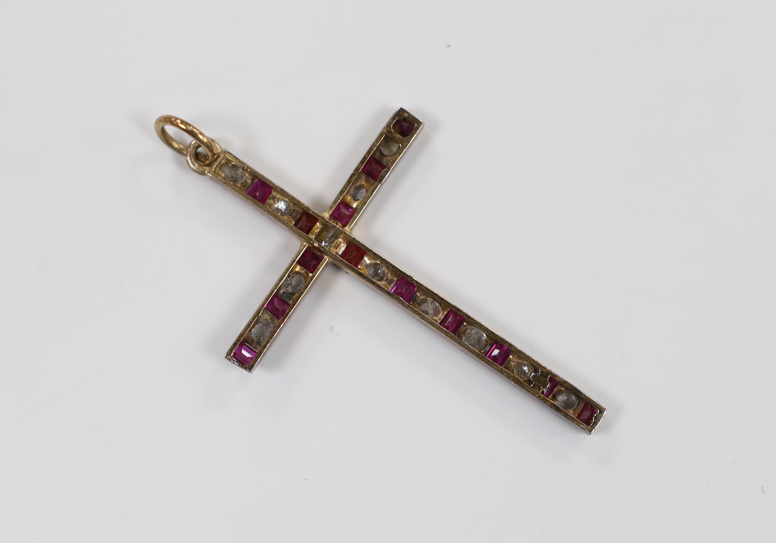 An early 20th century yellow metal, flat cut diamond and ruby set cross pendant, 45mm, gross weight 3.3 grams